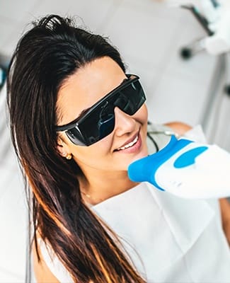 woman getting teeth whitened from her cosmetic dentist