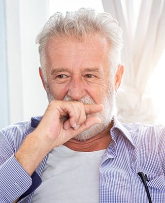 older man covering mouth