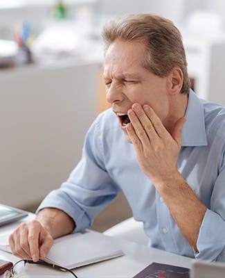 man yawning in pain