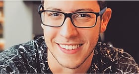 Teenage boy with glasses smiling