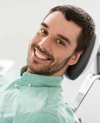 man in green shirt smiling