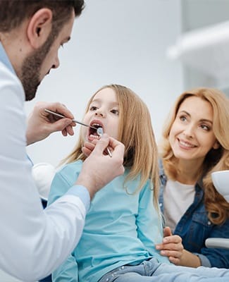 little girl getting teeth checked