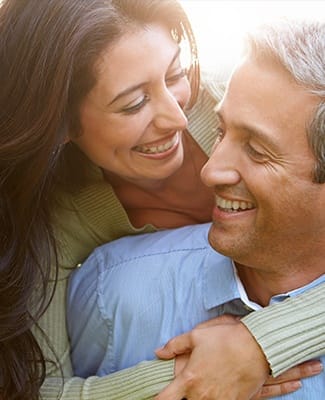 husband and wife smiling at each other