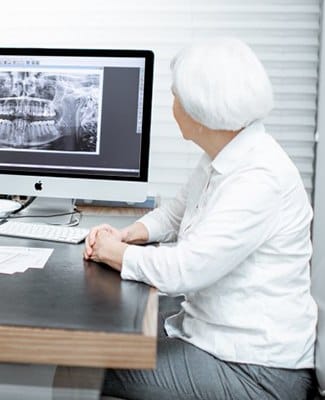 dentist explaining a patient’s dental X-rays to her 