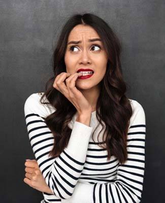 woman nervously biting her fingernails