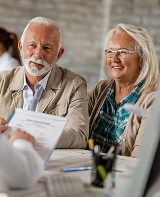 elderly couple attending a dental implant consultation