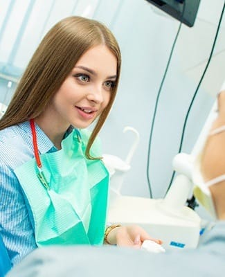 young woman talking to her dentist