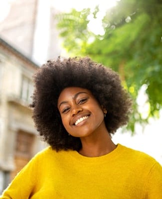 person smiling and walking outside