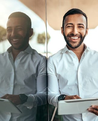 person smiling and touching a tablet