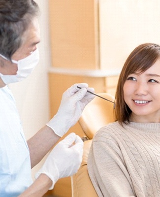 woman talking to her dentist at her checkup