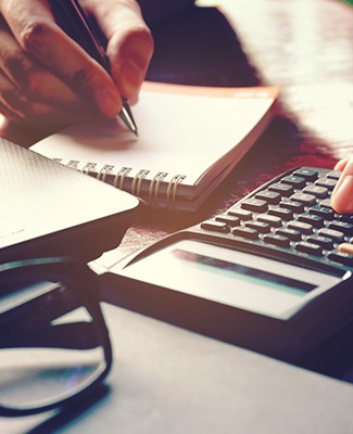 Woman calculating cost of tooth extraction in Federal Way