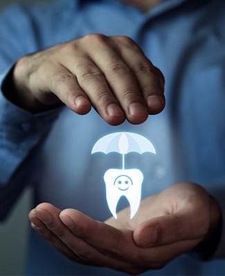 man holding tooth with umbrella