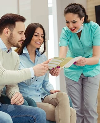 assistant showing couple paperwork