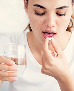 Woman taking a pill