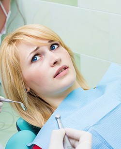 Woman afraid in the dental chair