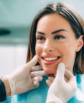 woman receiving oral cancer screening