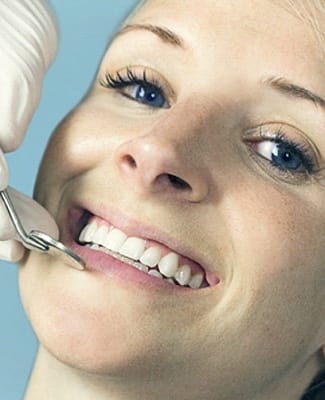 woman smiling receiving dental checkup