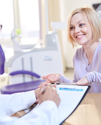 Dentist explaining cost of root canal therapy in Federal Way