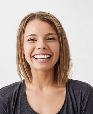 young woman in black shirt smiling after smile makeover in Federal Way 