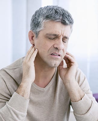 man holding both sides of jaw