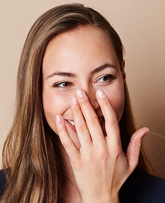 woman covering smile