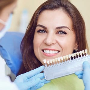 Young woman happy she could afford teeth whitening