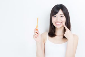 Smiling woman holding toothbrush