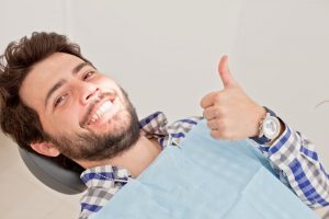 Man smiling in dentist's chair.