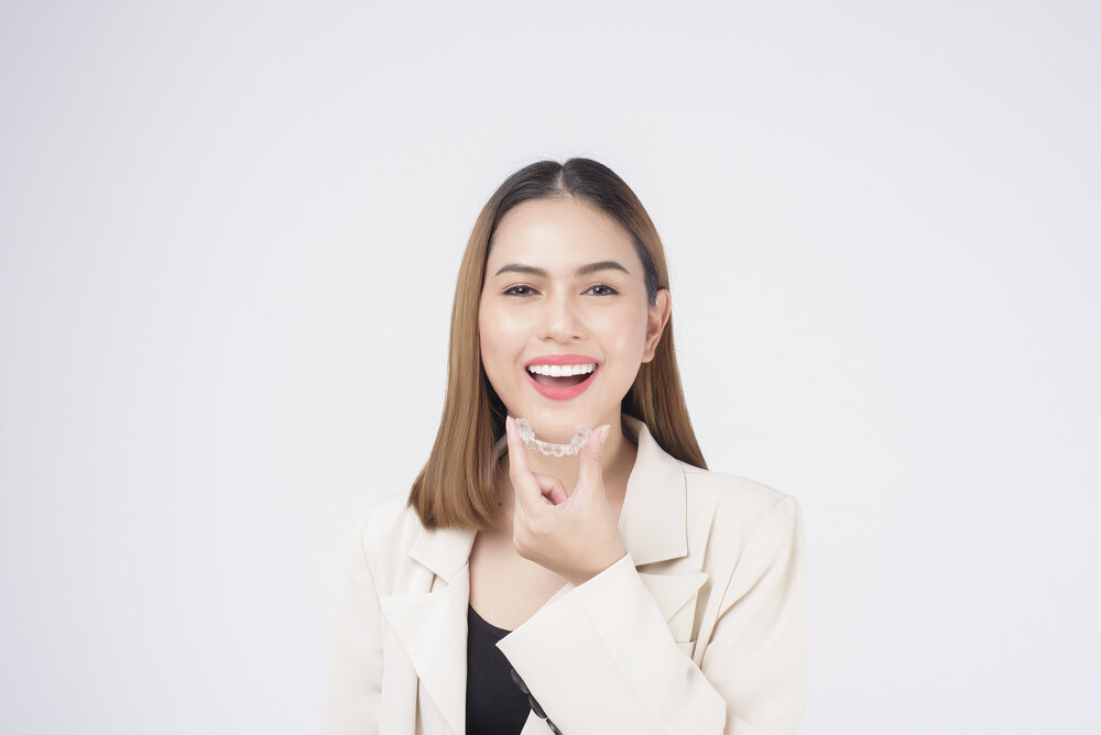 woman smiling with her Invisalign in Oakton