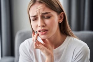 Woman suffering from a dental emergency