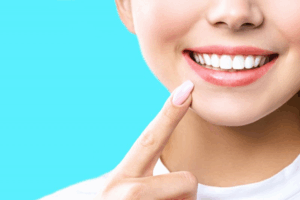 Close up of a patient smiling and tapping their chin