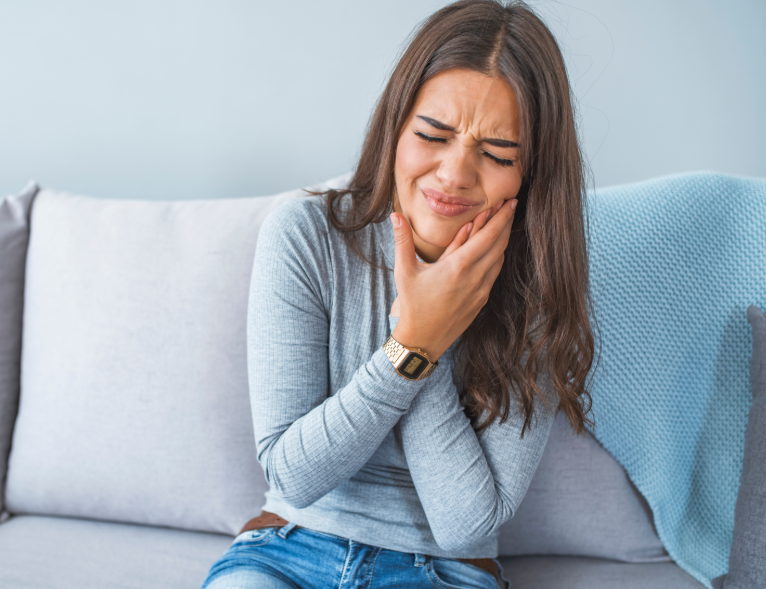 Woman holding jaw in pain